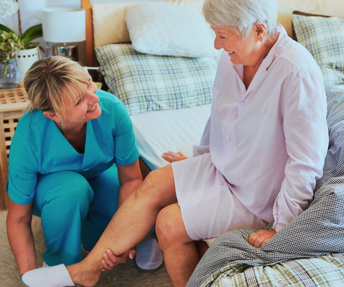 Caregiver helping elderly woman